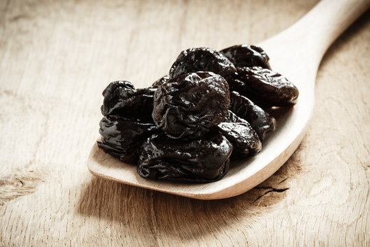 Dried Plums Prunes On Wooden Spoon