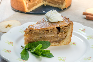 One Slice Apple Pie with Whipped Cream and Mint on a Plate