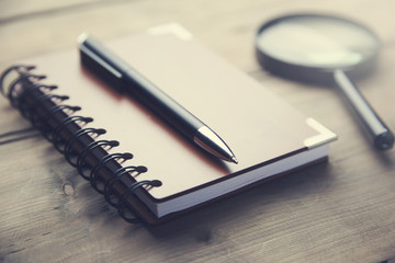 notebook and reading glass