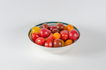 Close up from above of wild gourmet tomatoes on white background