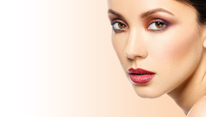 Fototapeta premium Beautiful adult woman face with smokey makeup on white backgroun