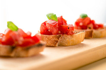 Bruschetta is an italian food made of chopped tomatoes, garlic, basil and fresh herbs on a toasted bread. These are traditionally served as snacks or antipasti (appetizers).