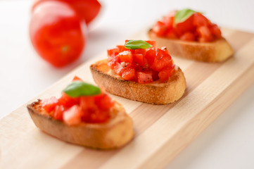 Bruschetta is an italian food made of chopped tomatoes, garlic, basil and fresh herbs on a toasted bread. These are traditionally served as snacks or antipasti (appetizers).