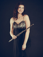 Elegant woman with flute instrument.