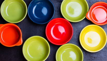 Different colorful bowl on black background