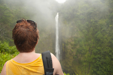 Enjoying tropical waterfall at Big Island of Hawaii on a rainy day