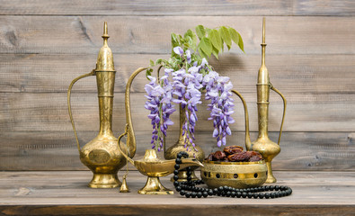 Fototapeta na wymiar Vintage arabic jug lamp tea pot islamic rosary beads