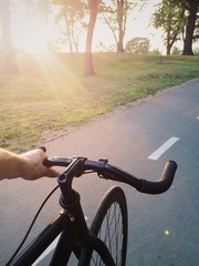 Fototapeta na wymiar Bike ride at sunset in the park