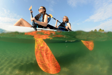 Two young women smiling in kayak