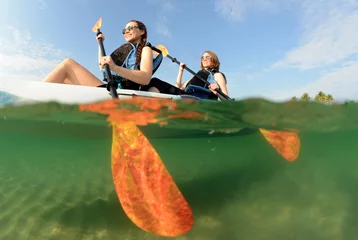 Foto op Canvas Two young women smiling in kayak © ftlaudgirl