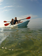 kayak in ocean with two women