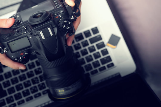 Digital Photography Workstation. Modern Digital DSLR Camera, Laptop Computer and Display.