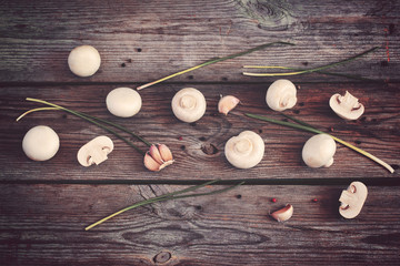 Vintage wooden background with mushrooms, peppercorns and herbs