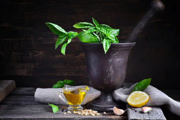 italian recipe ingredients for basil pesto on a dark background,
