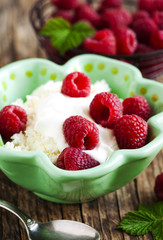 Fresh cottage cheese with raspberries and sour cream. Healthy br