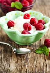 Fresh cottage cheese with raspberries and sour cream. Healthy breakfast