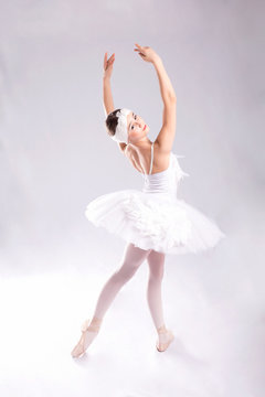 Ballerina  is dancing on a white background