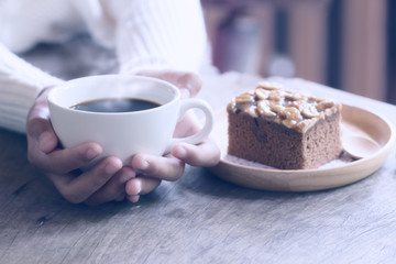 hands holding hot cup of coffee