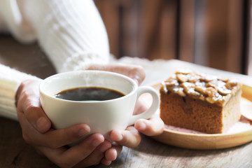 hands holding hot cup of coffee