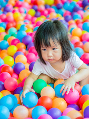 Fototapeta na wymiar Happy Asian girl playing with balls