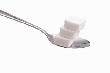 sugar cubes in aspoon isolate on white with clipping paths