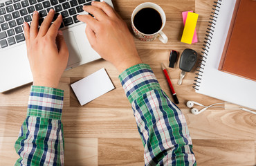 Man writing an email with blank business card closeup shot at office table