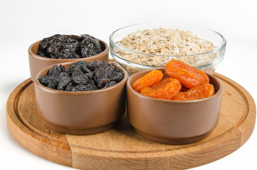 oatmeal in a glass bowl and dried fruits