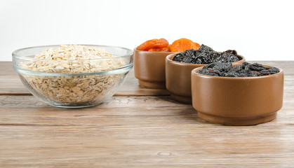 oatmeal in a glass bowl and dried fruits