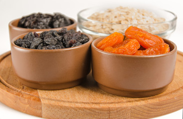 oatmeal in a glass bowl and dried fruits
