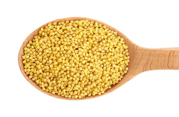 Wooden spoon with millet gruel isolated on white background.