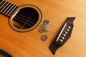 Fototapeta premium coin money lies on the acoustic guitar