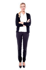 Confident young business woman in full length.
