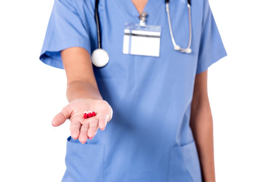 Medical pills in doctor's hand.