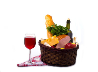 basket with food for a picnic with a glass of wine