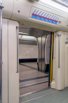 View of the subway station through the open doors of the train wagon