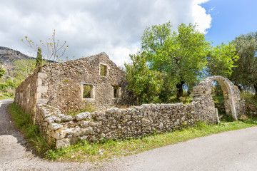 Old historic house as ruins along road