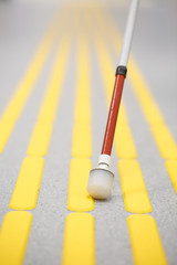 Blind pedestrian walking on tactile paving