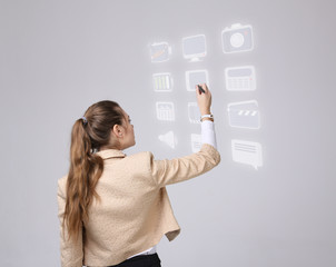 Woman pressing multimedia and entertainment icons on a virtual background