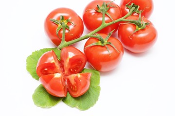 Fresh red organic tomatoes on a white background