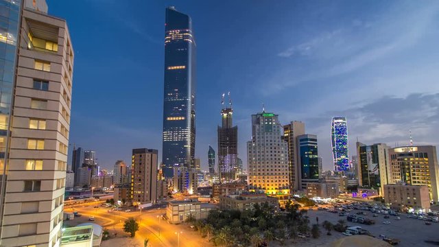 Skyline with Skyscrapers day to night timelapse in Kuwait City downtown illuminated at dusk. Kuwait City, Middle East