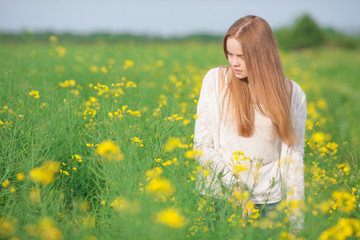 Naklejka na ściany i meble Pollen allergy, girl sneezing in a field of flowers.