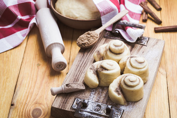 Making cinnamon buns. Homemade yeast dough after raising