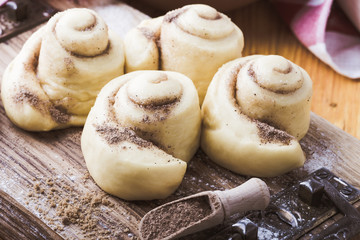 Naklejka premium Making cinnamon buns. Homemade yeast dough after raising