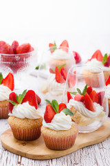 Homemade cupcakes  and sponge layer cake with  strawberries in a