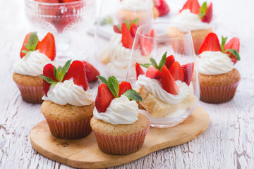 Homemade cupcakes  and sponge layer cake with  strawberries in a