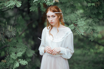 Obraz premium Beautiful artistic photo portrait of a mysterious girl in white dress in the woods