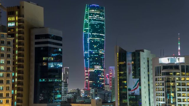 Skyline with Skyscrapers night timelapse in Kuwait City downtown illuminated at dusk. Kuwait City, Middle East