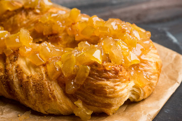 Apple strudel on the rustic wooden background. Shallow depth of field.