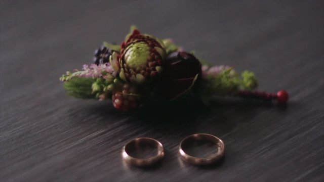 Rings and Flowers. Groom's Boutonniere Closeup