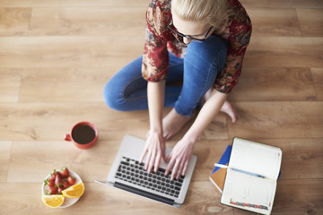 Working with laptop on the floor